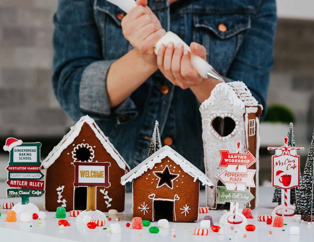 woman decorating gingerbread house