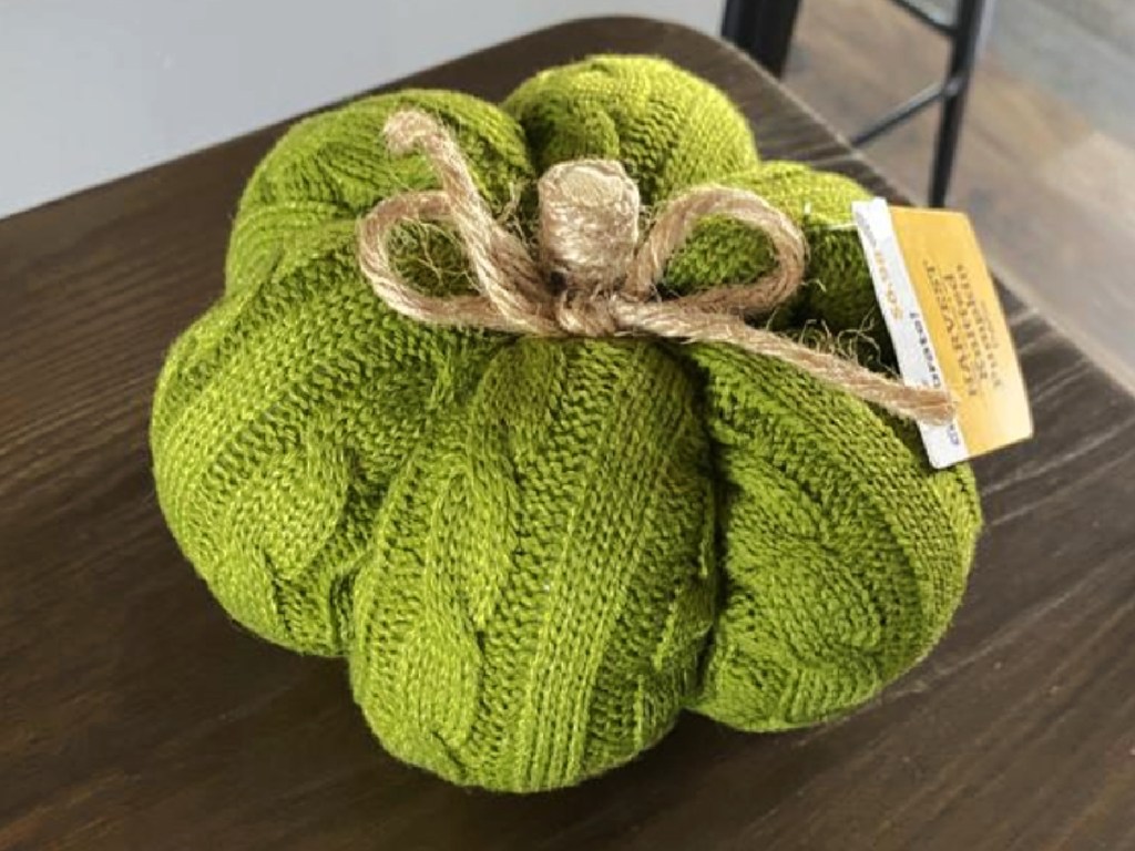 green knit fabric pumpkin on tabletop