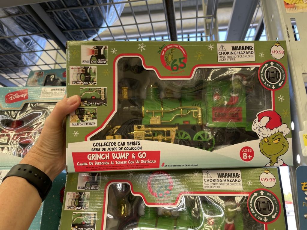 hand holding a Grinch Train