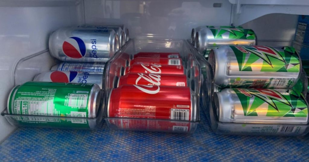 3 soda can organizer bins in fridge with soda cans in them