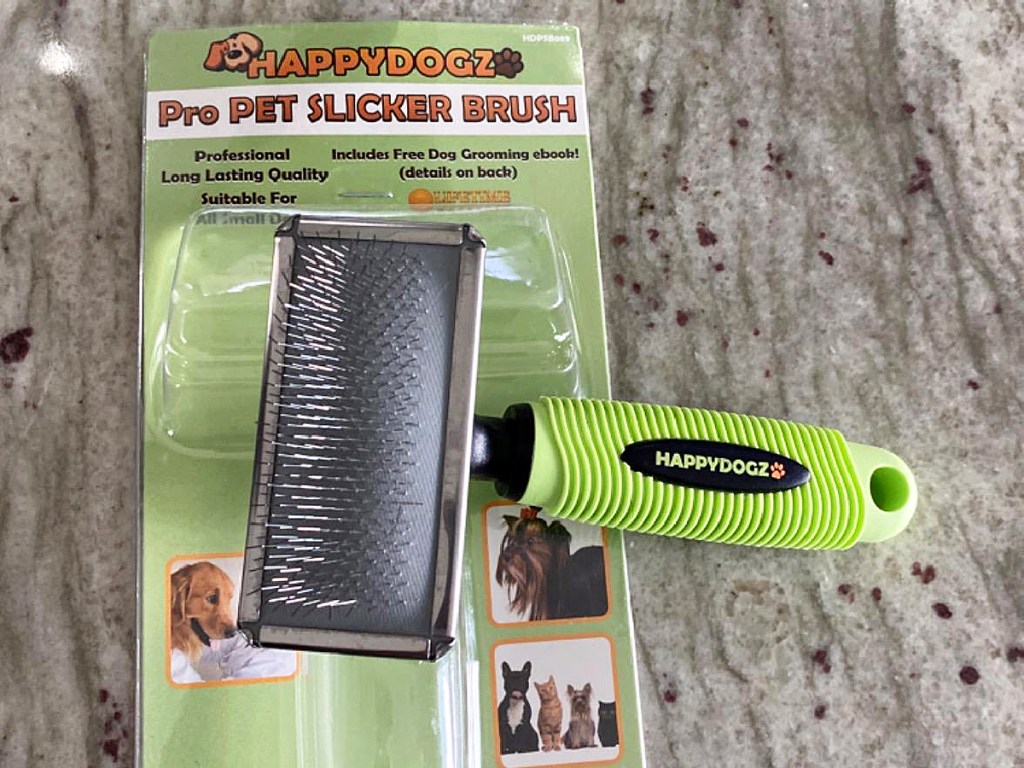 green pet hair grooming tool