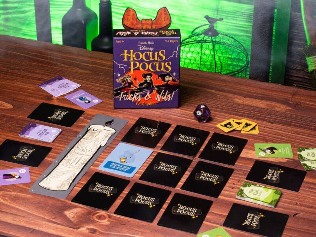 Funko Disney Hocus Pocus Tricks & Wits Card Game shown laid out on a table with spooky decorations