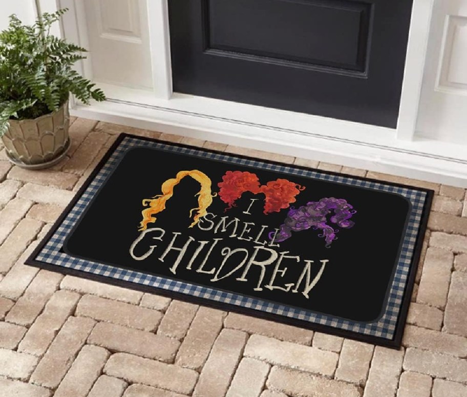 A hocus pocus halloween doormat outside a front door