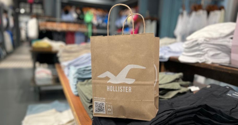 A hollister shopping bag on a tale of folded pants