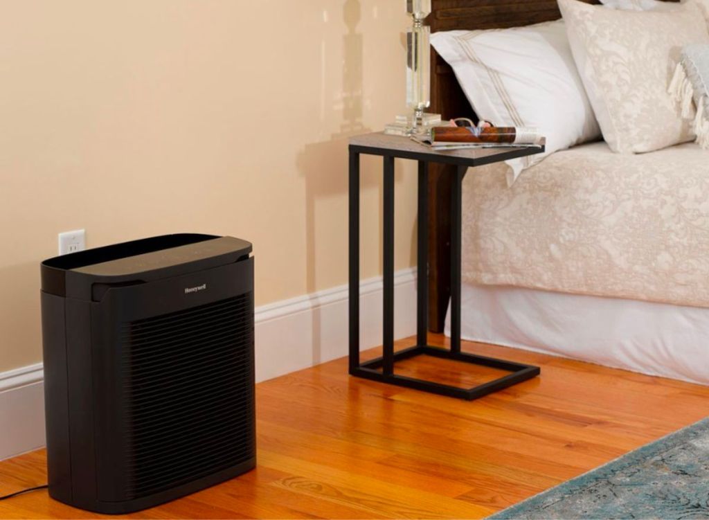 Honeywell PowerPlus HEPA Air Purifier in a bedroom next to the wall