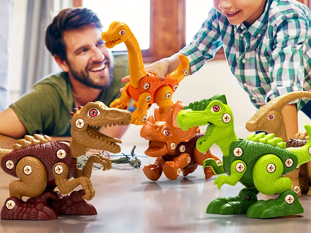 playing with toy dinosaur set