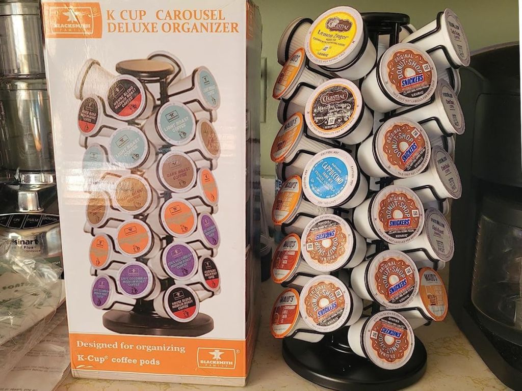 A K-Cup Carousel Organizer with K-Cups in it beside the box