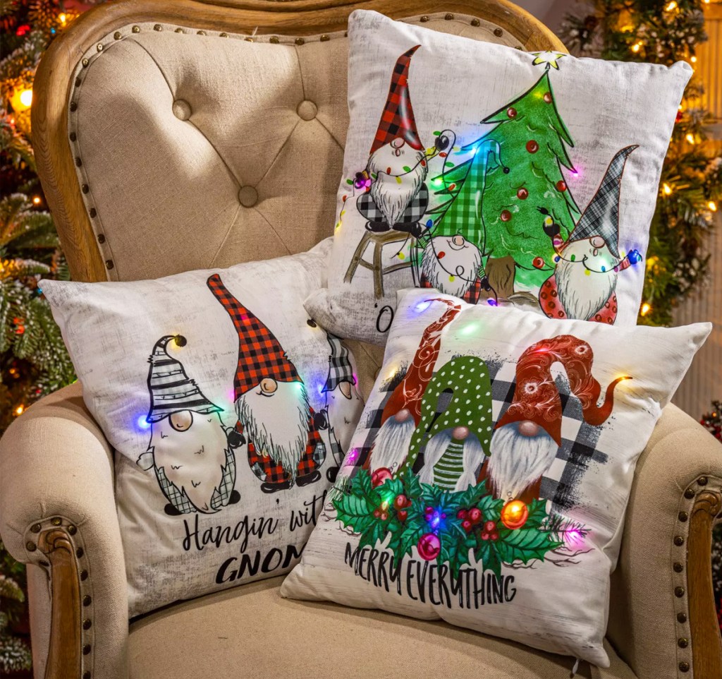 three light up gnome pillows on a chair