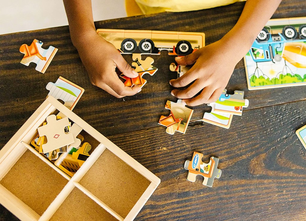kid playing with construction truck puzzle