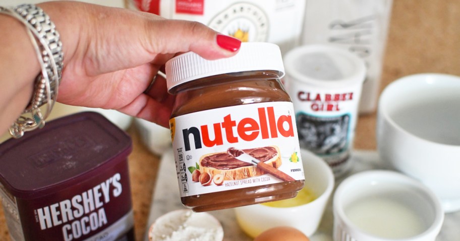 hand holding jar of Nutella