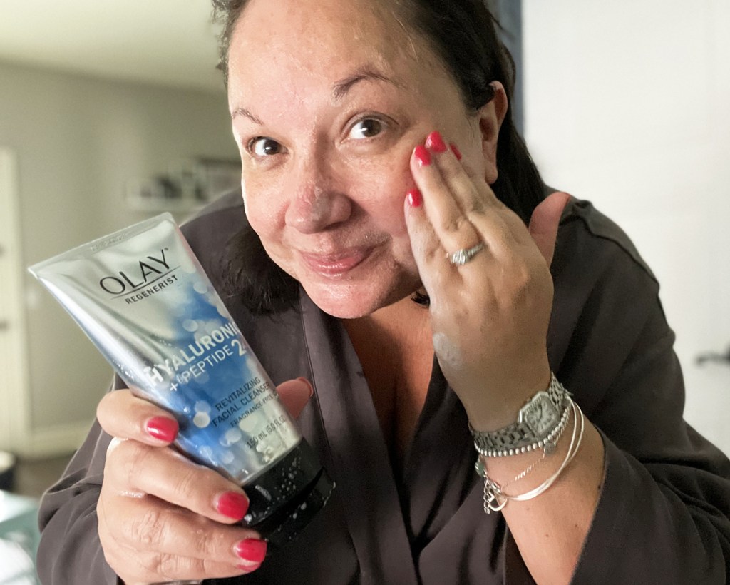 woman using olay cleanser
