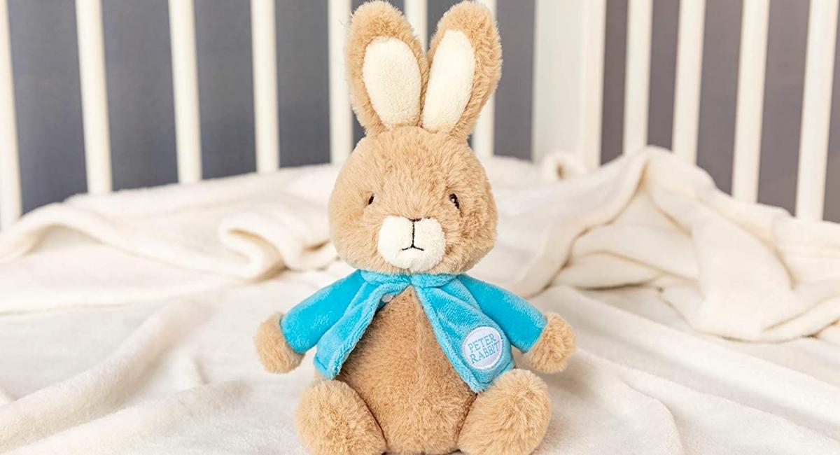 Peter Rabbit Plush Bunny in a crib with blankets