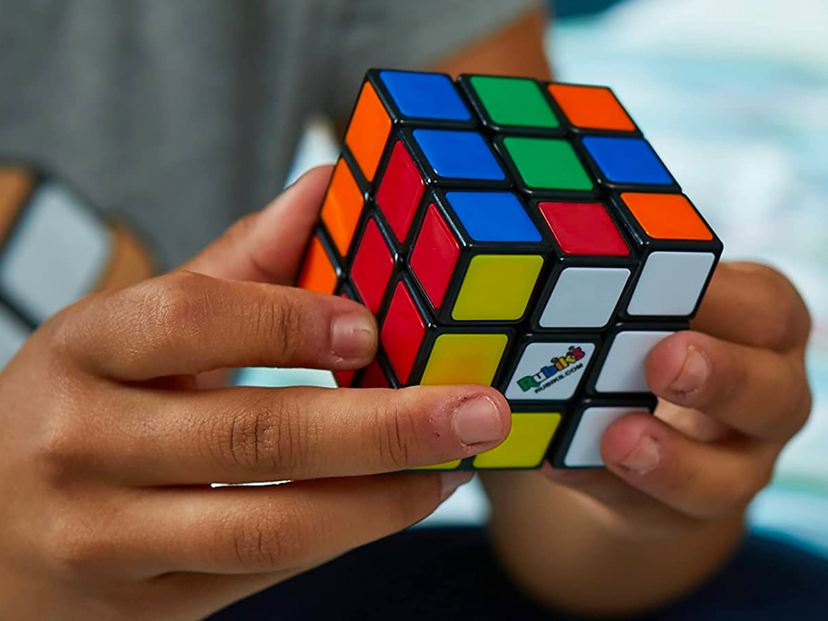 close up of a pair of hands playing with a Rubik's Cube