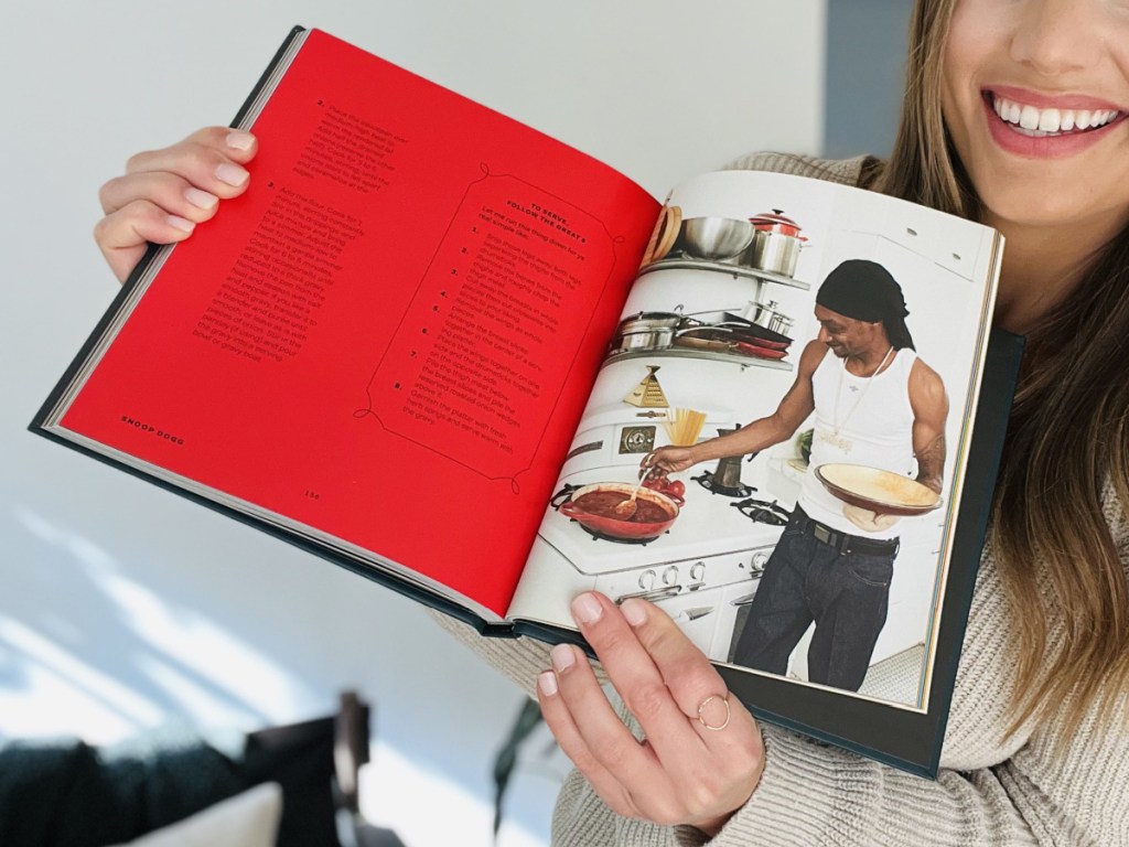 person holding up Snoop Dog Cookbook open on recipe page