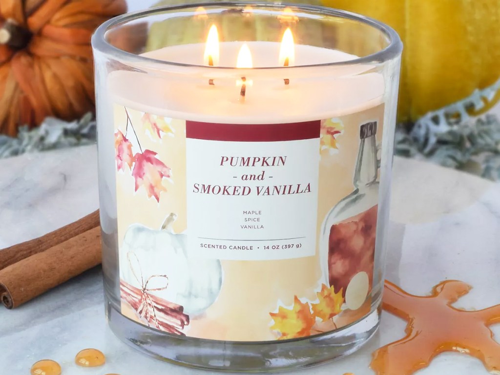 pumpkin and vanilla 3-wick candle burning