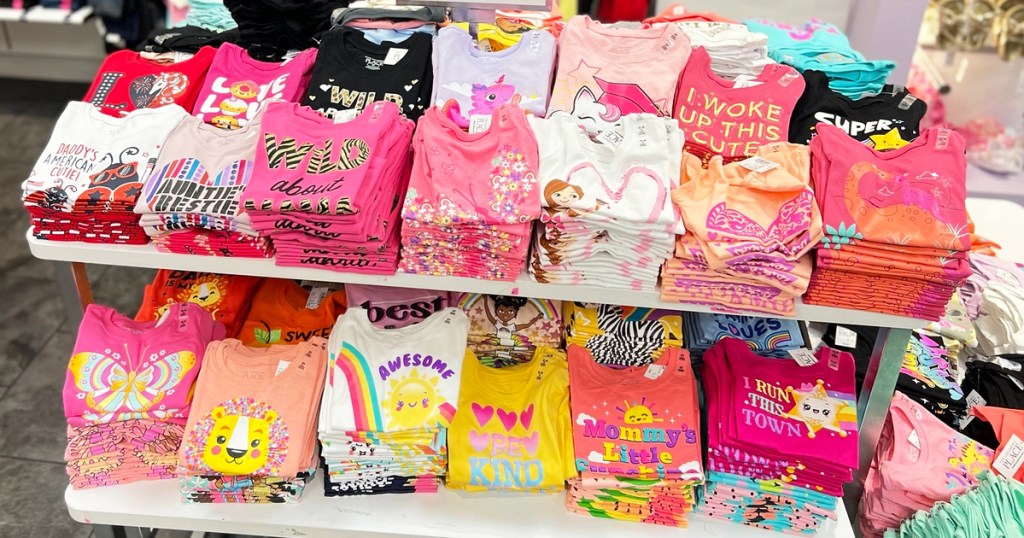display of girls graphic tees in store
