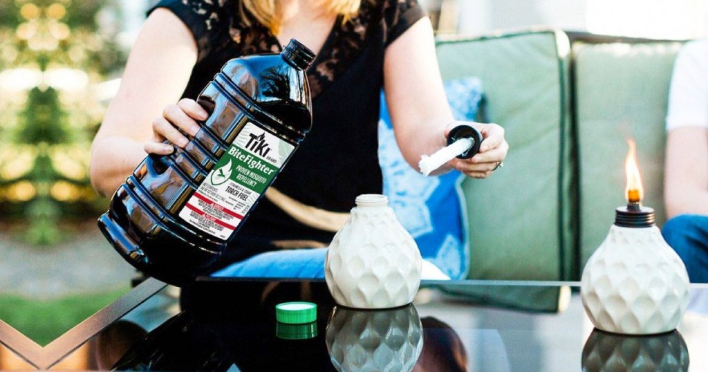 pouring bottle of TIKI Bitefighter Torch Fuel