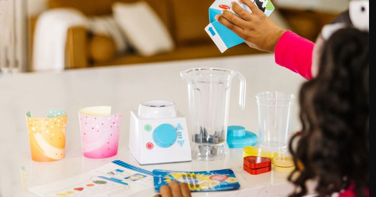 girl playing with a melissa and doug smoothie maker and pieces