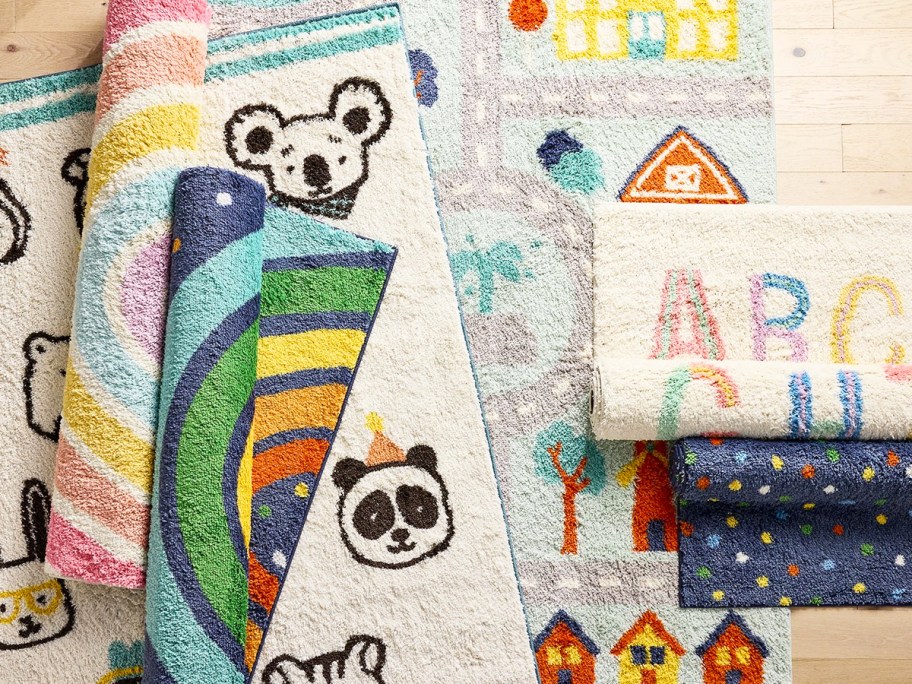kids area rugs in various prints on top of one another