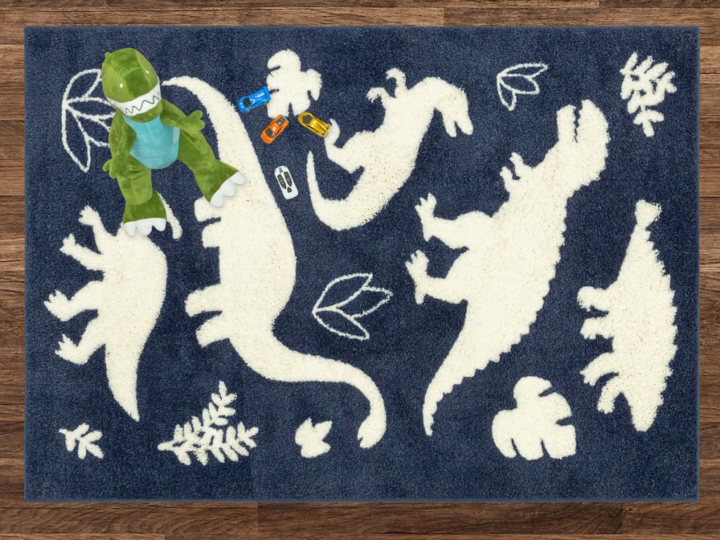 navy and white dinosaur print area rug on wood floor
