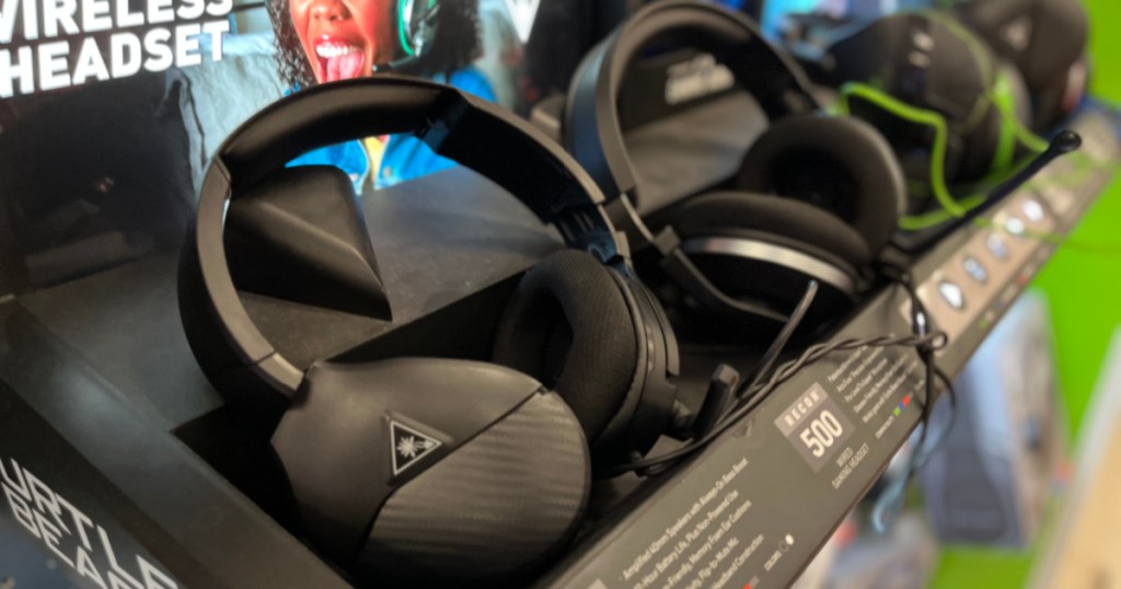 two black gaming headsets on shelf