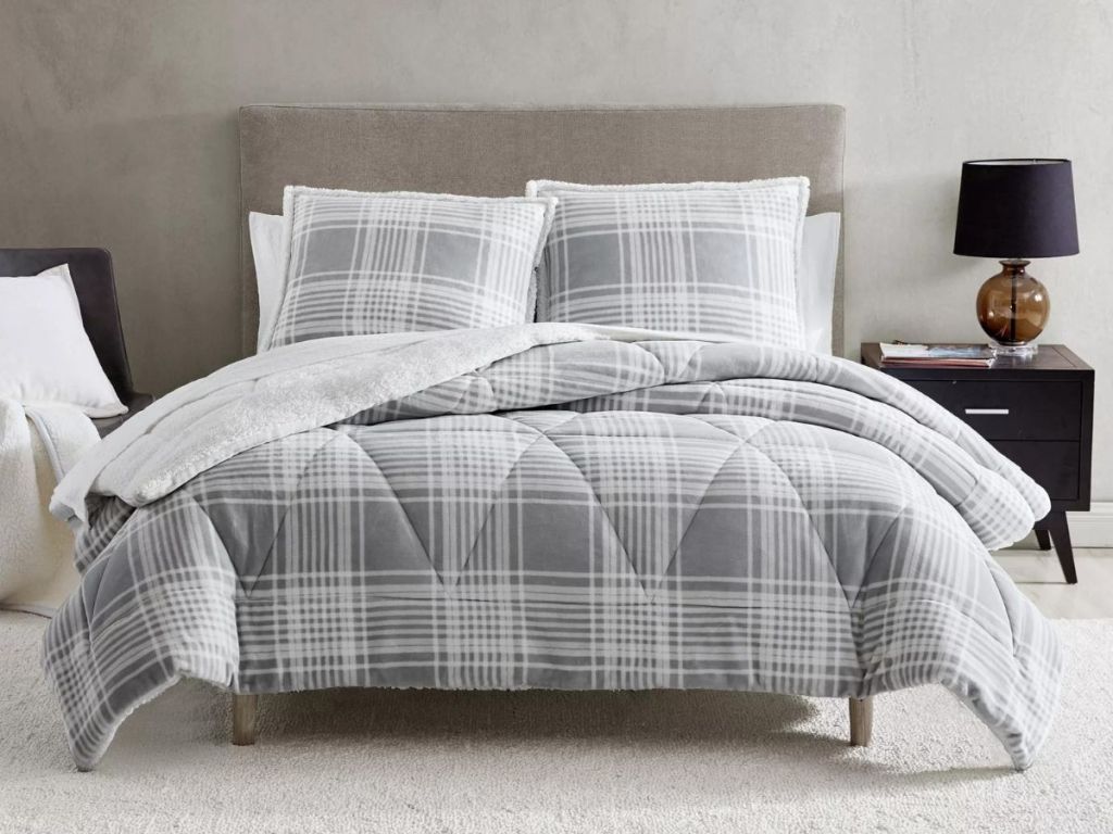 gray and white plaid comforter on bed