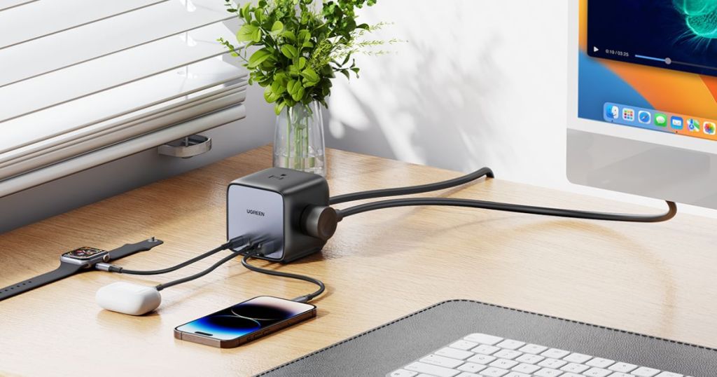 various electronics plugged into UGREEN black charging block on desk