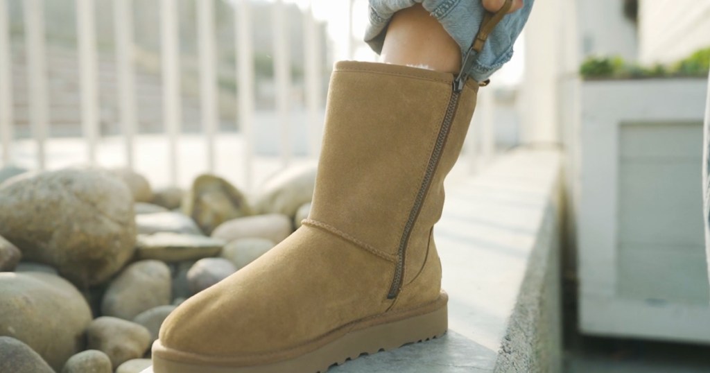 zipping up brown ugg boot