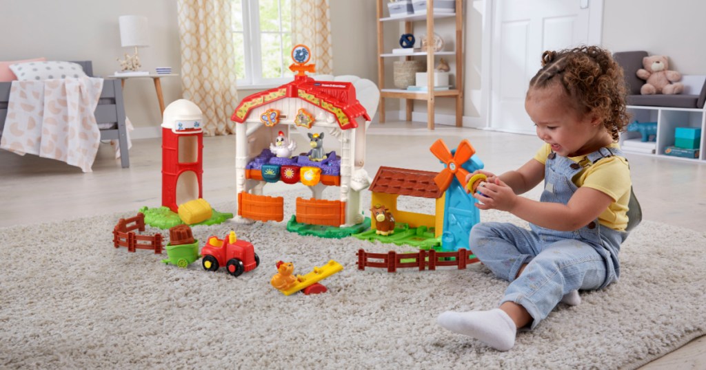 girl playing with farm playset on living room floor