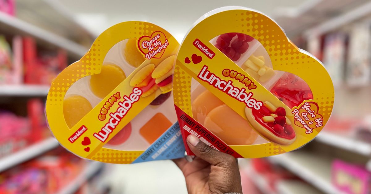 hand holding up two boxes of gummy Lunchables in a store aisle