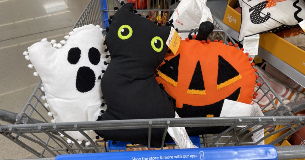 three Halloween pillows in store cart