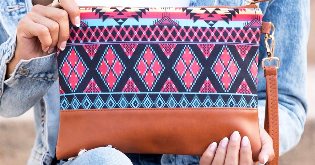 woman holding large printed clutch