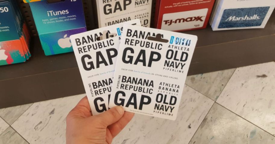 two banana republic gift cards being held by hand in store