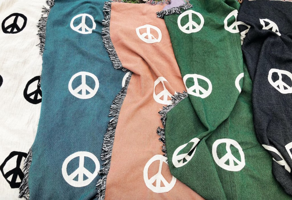 various peace sign fabrics laying flat in a row