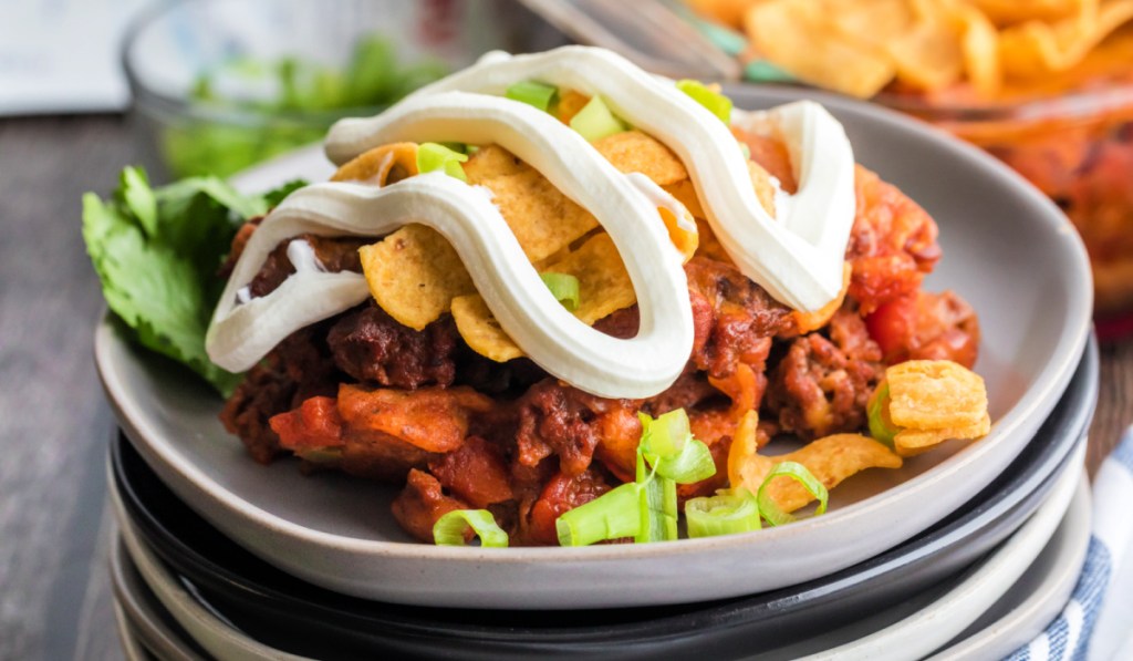 frito pie on a plate with sour cream