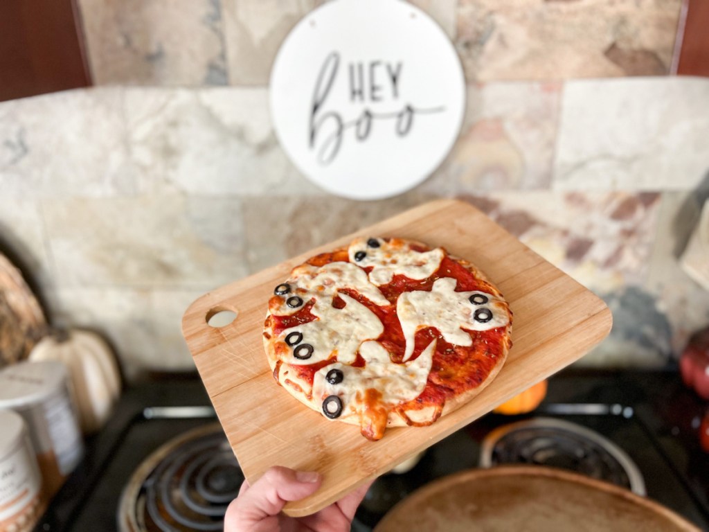 ghost pizza with olive eyes on a pan