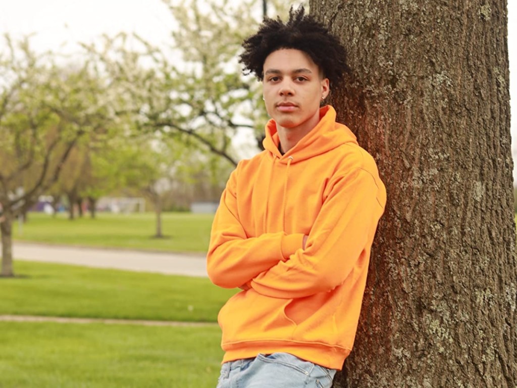 young man wearing a yellow hoodie