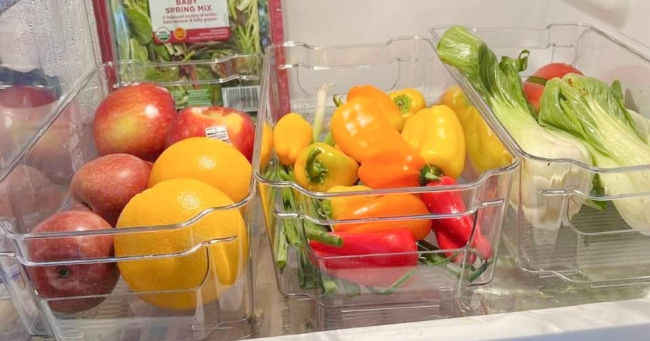 clear plastic bins with fruit and veggies inside in fridge