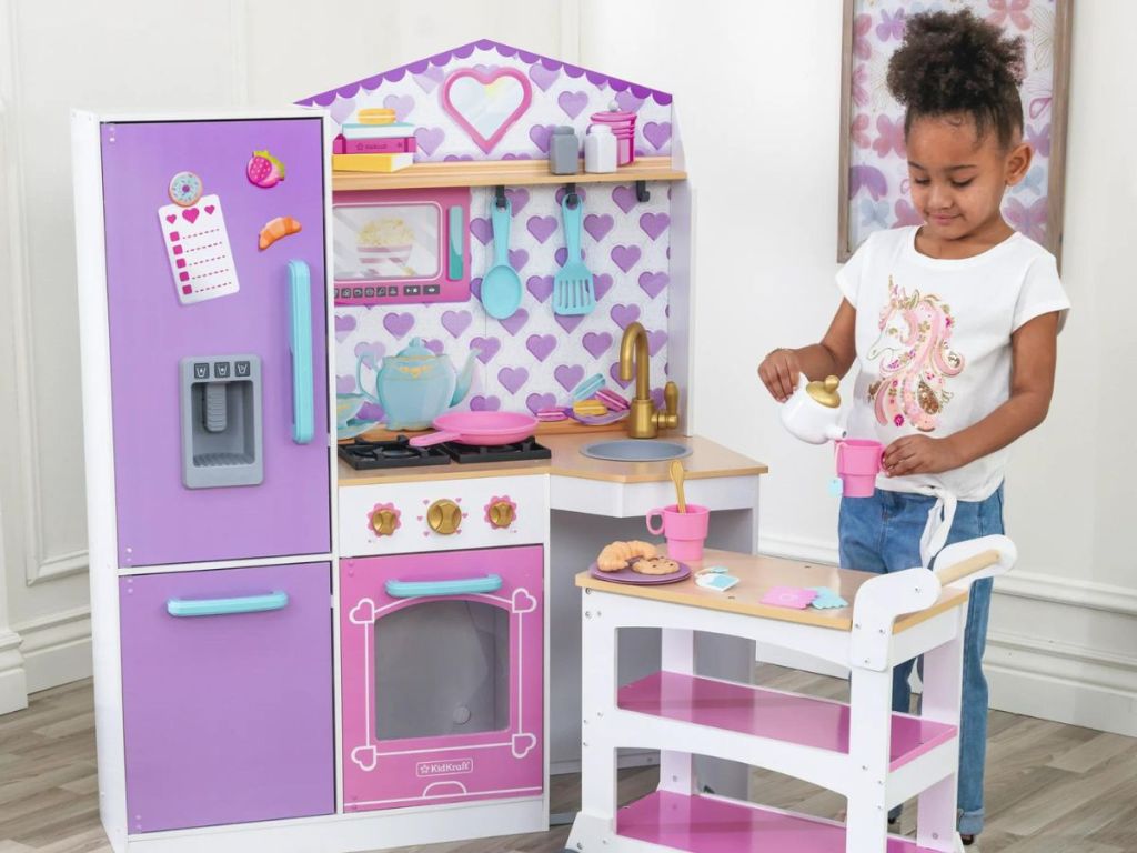 girl playing with Kidkraft kitchen set