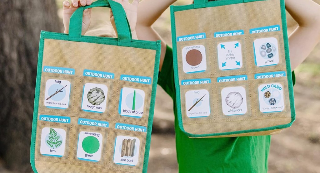 kids holding up play shopping bags with tools to find outdoors