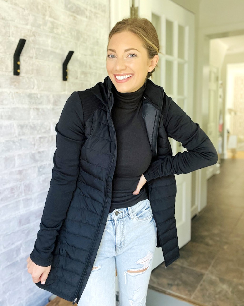 woman smiling wearing black parka jacket