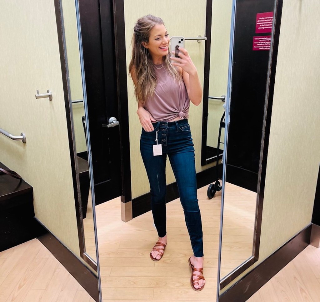 woman taking dressing room selfie wearing skinny jeans