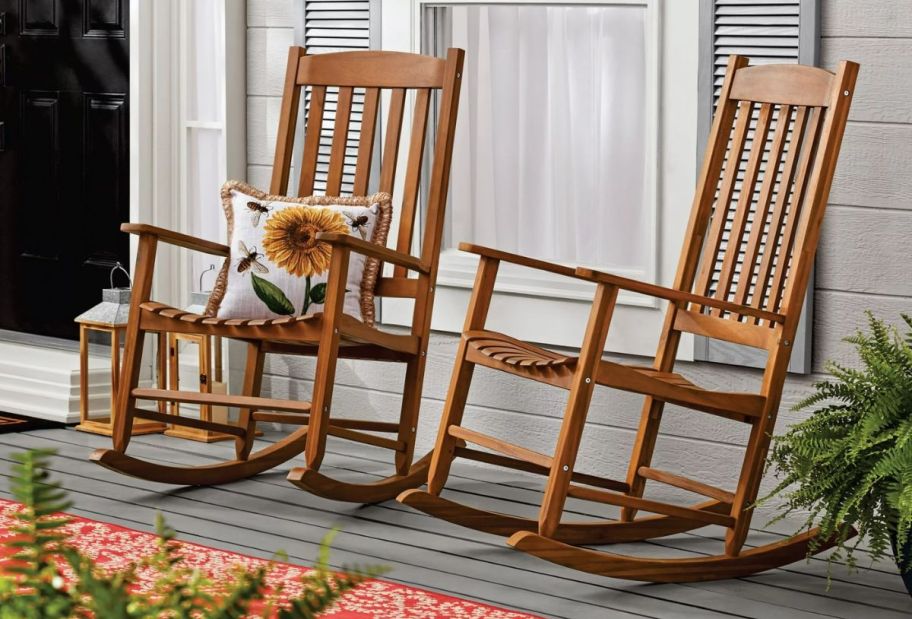 two natural colored rocking chairs on a front proch