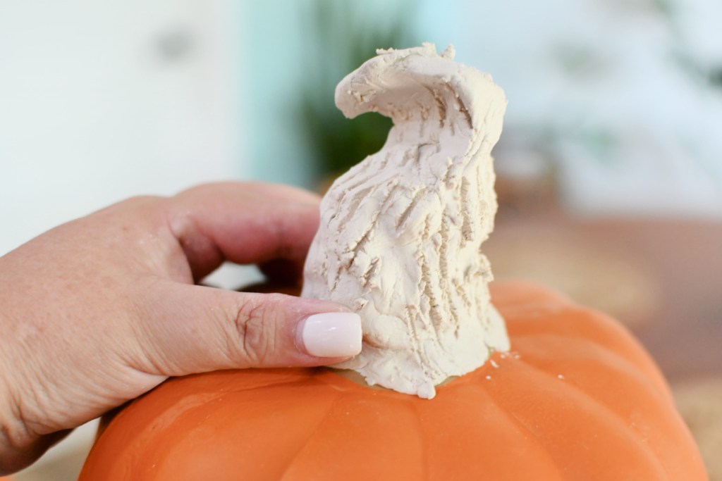 making a pumpkin stem with molding clay