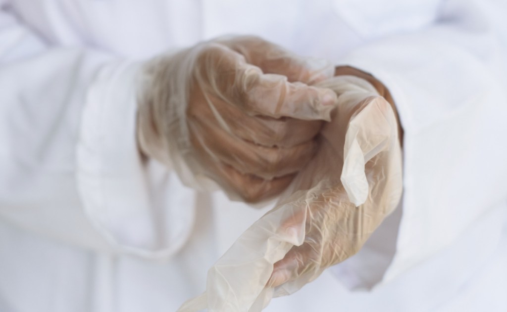 medical professional putting gloves on