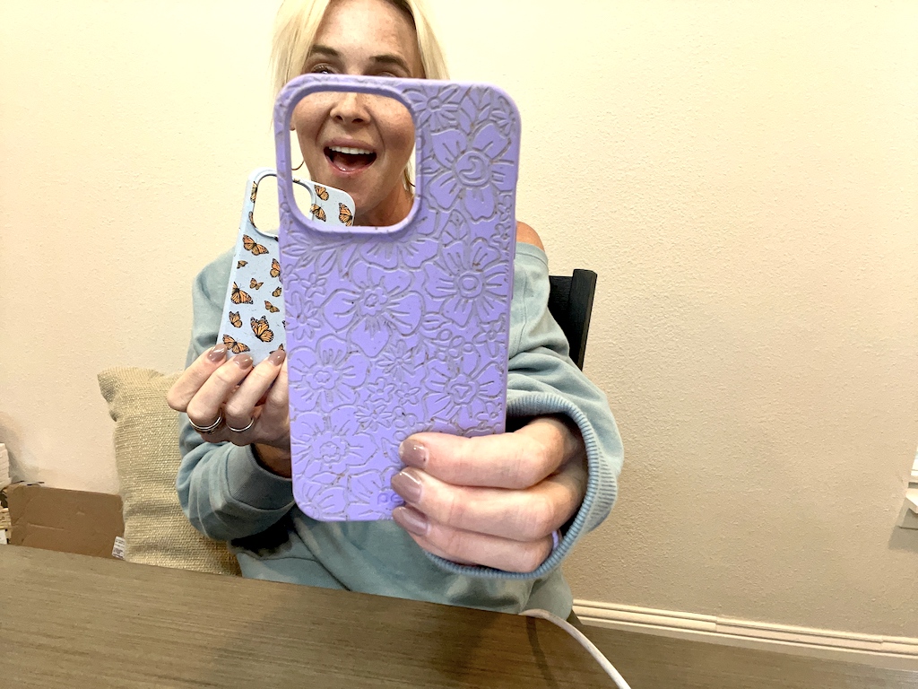 woman holding two Pela phone cases 