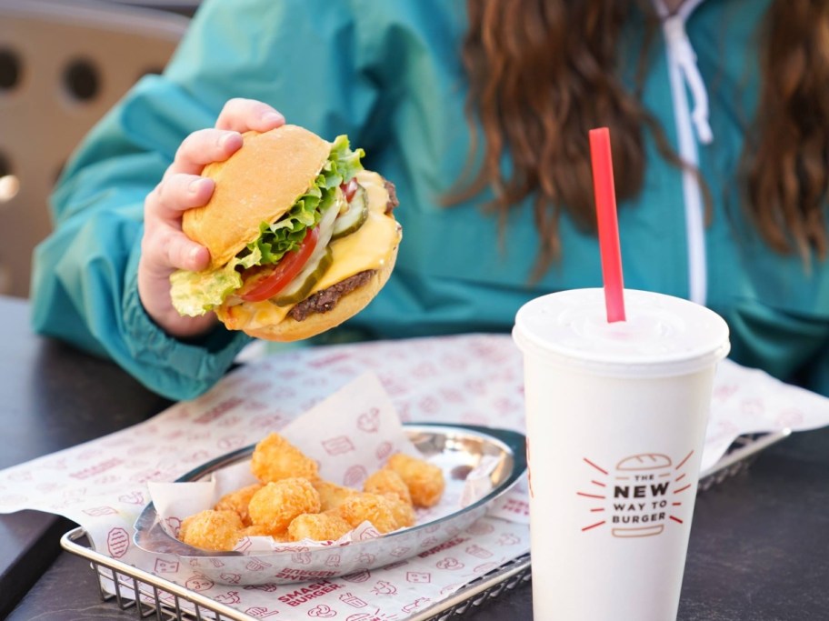 holding a burger at a fast food restaurant