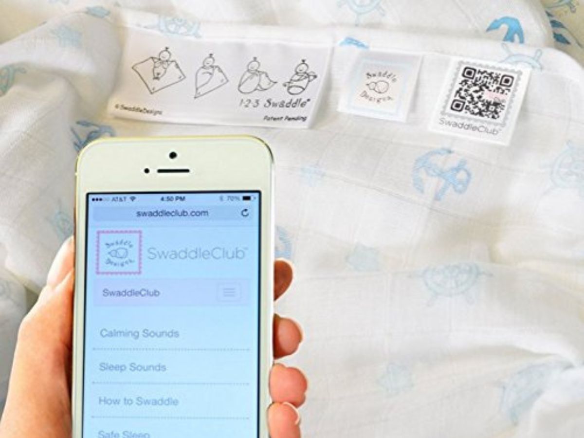 Ultimate Swaddle blanket and app on phone