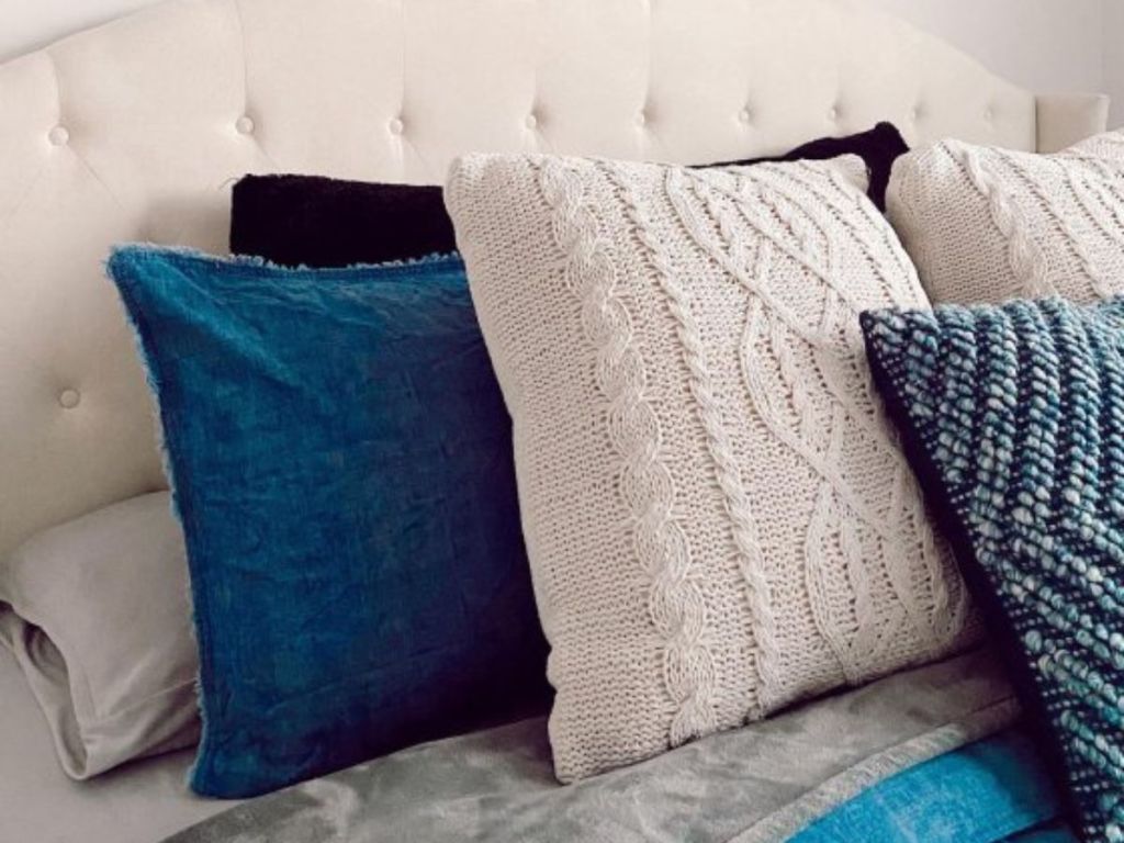 blue and gray throw pillows on bed 
