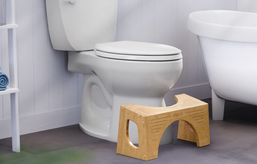 toilet with bamboo squatty potty in the bathroom